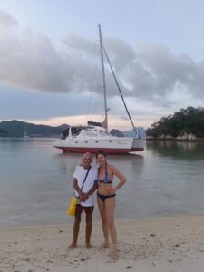 Guests ashore at low tide with the Maria catamaran in the background