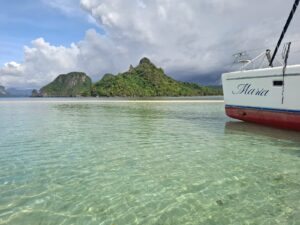 The bow of Maria in shallow clear water near the islands of El Nido